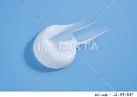 A smear of white cream on a blue background. 123047834