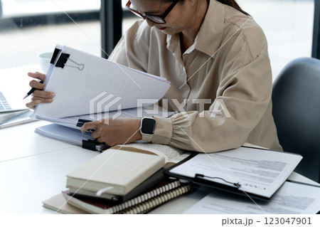 Elder businesswoman in casual attire is thinking while sitting 123047901