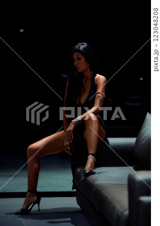 Sexy asian girl in black dress posing on sofa 123048208