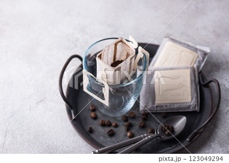 Freshly brewed drip coffee in glass cup Freshly brewed drip coffee in glass cup 123049294