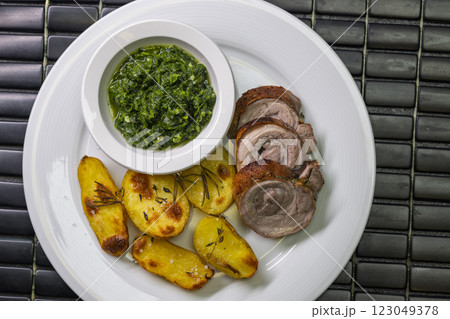 pork roll with spinach and roasted potatoes pork roll with spinach and roasted potatoes 123049378