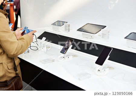 Buyer hands with mobile smartphones in electronics store Buyer hands with mobile smartphones in electronics store 123050166