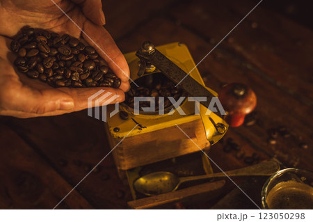 Pour coffee beans into the grinder Pour coffee beans into the grinder 123050298