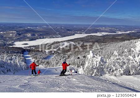 Children skiers enjoying the aerial view of Mont Tremblant resort, Quebec, Canada 123050424