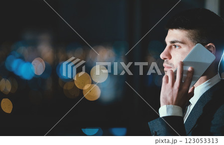 Entrepreneur Talking On Cellphone Standing Near Window With Night City View In Modern Office. Business Communication Concept. Copy Space, Side-View 123053313
