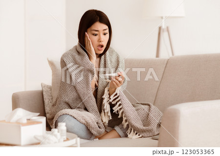 Check Temperature. Shocked Asian Girl Having Cold And High Fever, Using Digital Thermometer Check Temperature. Shocked Asian Girl Having Cold And High Fever, Using Digital Thermometer 123053365