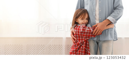 You are my hero. Sweet smiling little girl hugging her dad at home, staying next to window, close up, copy space You are my hero. Sweet smiling little girl hugging her dad at home, staying next to window, close up, copy space 123053432