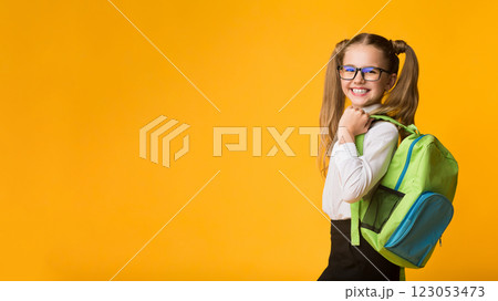 Schoolgirl Posing With School Backpack Smiling To Camera Standing Over Yellow Background. Studio Shot Schoolgirl Posing With School Backpack Smiling To Camera Standing Over Yellow Background. Studio Shot 123053473