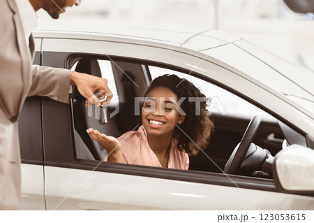 Buying Car. Automobile Seller Giving Black Lady Key For Test Drive In Dealership Showroom. Selective Focus, Cropped 123053615