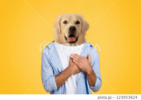 A person stands smiling with their arms crossed over their chest, featuring a golden retriever's head superimposed on their body. The solid yellow background emphasizes the playful and humorous nature 123053624