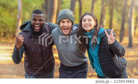 Emotional international group of tourists posing over autumn forest background 123053662