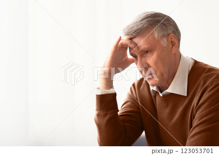 Stress. Depressed Senior Man Thinking About Problems Touching Head Sitting Against Window At Home. Selective Focus, Empty Space Stress. Depressed Senior Man Thinking About Problems Touching Head Sitting Against Window At Home. Selective Focus, Empty Space 123053701