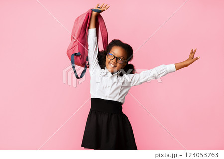 Back To School. Carefree African American Schoolgirl With Backpack Posing Over Yellow Background. Studio Shot Back To School. Carefree African American Schoolgirl With Backpack Posing Over Yellow Background. Studio Shot 123053763
