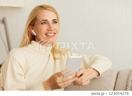 Mature Woman Listening Music In Airpods, Having Rest At Home, Free Space Mature Woman Listening Music In Airpods, Having Rest At Home, Free Space 123054278