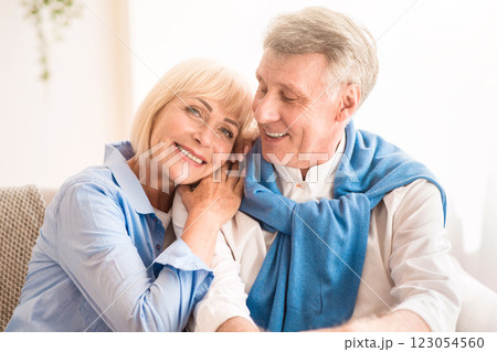 Happy mature couple enjoying time at home and relaxing on sofa 123054560