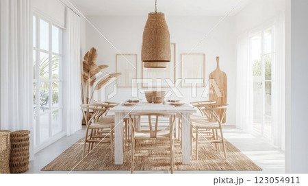 The dining area features a large wooden table surrounded by stylish chairs, enhanced by wicker light fixtures and natural decor elements 123054911