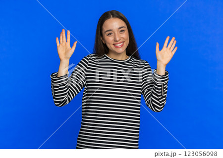 Happy woman smiling friendly waving hands gesturing hello greeting or goodbye, meeting invitation Happy woman smiling friendly waving hands gesturing hello greeting or goodbye, meeting invitation 123056098