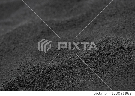 Texture of black volcanic sand on the Hawaii ocean beach. 123056968