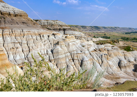 Canyon in badlands with eroded formations on the hills in summer. Canyon in badlands with eroded formations on the hills in summer. 123057093
