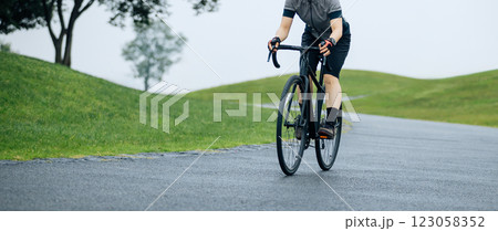 Woman biking on summer park trail 123058352