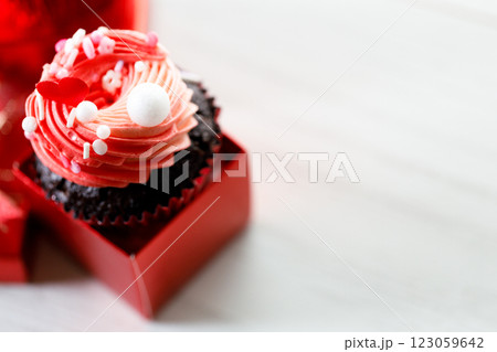 Chocolate cupcake with pink cream and heart shaped sprinkles. Chocolate cupcake with pink cream and heart shaped sprinkles. 123059642