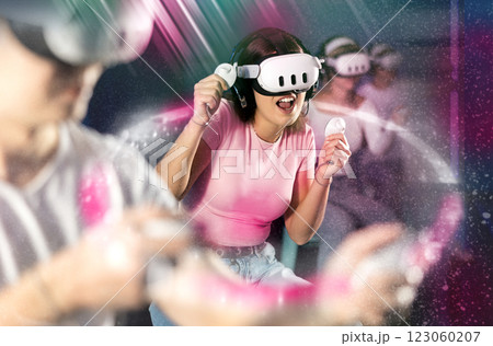 Girl in a virtual reality helmet in bright rays Girl in a virtual reality helmet in bright rays 123060207