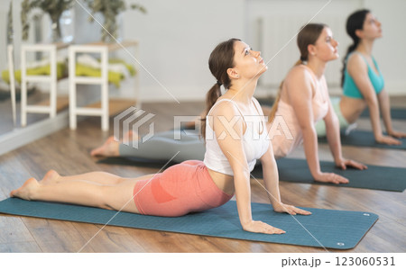 Young girl doing Upward Facing Dog pose in yoga studio Young girl doing Upward Facing Dog pose in yoga studio 123060531