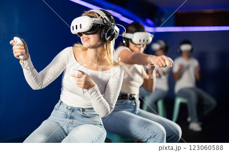Two girls wearing virtual reality glasses participate in game with opponents 123060588