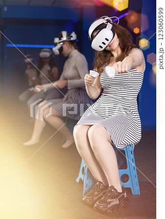 Girls wearing VR headsets and playing games. Modern bachelorette party 123060599