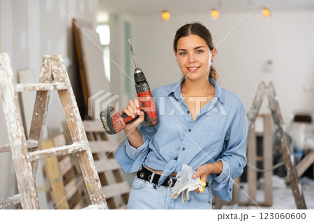 Portrait of a contented young woman with a screwdriver in hands 123060600