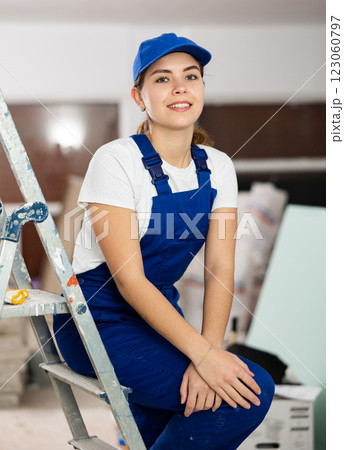 Enthusiastic young female builder inside house under construction Enthusiastic young female builder inside house under construction 123060797
