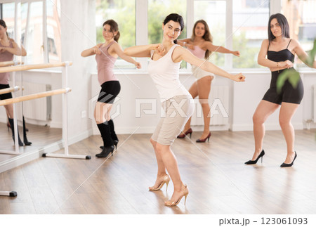 Young woman performing sass dance during group class 123061093