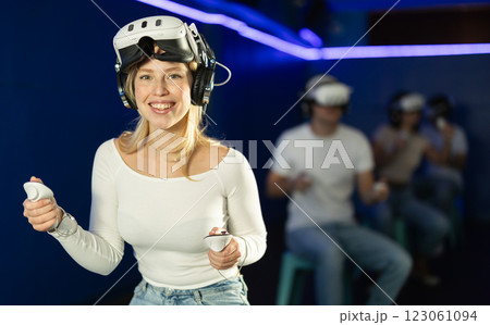 Girl in virtual reality glasses is playing a video game Girl in virtual reality glasses is playing a video game 123061094