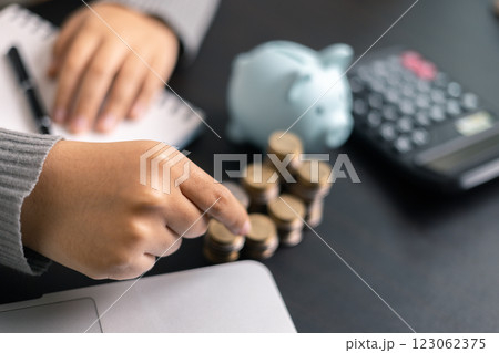 Finance bank tax expense accounting budget money businessman hand use calculator Financial calculate accountant close up calculator with graph chart write office desk Business expense analysis saving 123062375