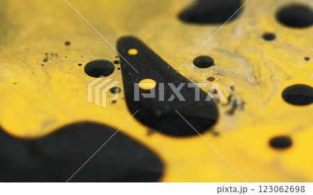 Blur spray blob. Fuel drop. Defocused yellow black color shiny glowing particles viscous oil spill drip texture paint ink water mix on abstract art background. Blur spray blob. Fuel drop. Defocused yellow black color shiny glowing particles viscous oil spill drip texture paint ink water mix on abstract art background. 123062698