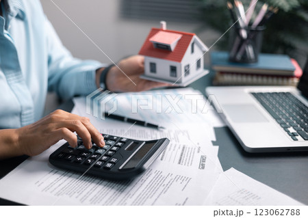 Finance bank tax expense accounting budget money businessman home for Business expense analysis saving use Financial calculate accountant close up calculator with graph chart hand write office desk 123062788