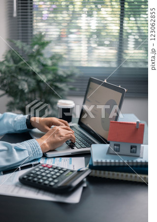 Finance bank tax expense accounting budget money businessman home for Business expense analysis saving use Financial calculate accountant close up calculator with graph chart hand write office desk 123062855