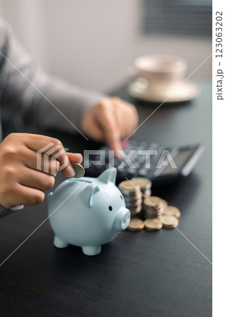 Finance bank tax expense accounting budget money businessman hand use calculator Financial calculate accountant close up calculator with graph chart write office desk Business expense analysis saving 123063202
