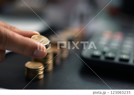 Finance bank tax expense accounting budget money businessman home for Business expense analysis saving use Financial calculate accountant close up calculator with graph chart hand write office desk 123063235