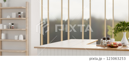 A minimalist kitchen island with decorative items, set in a minimalist white kitchen. A minimalist kitchen island with decorative items, set in a minimalist white kitchen. 123063253