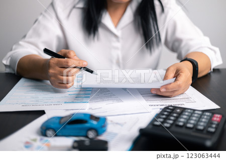 Finance bank tax expense accounting budget money businessman hand for Business expense analysis saving use car Financial calculate accountant close up calculator with graph chart write office desk 123063444