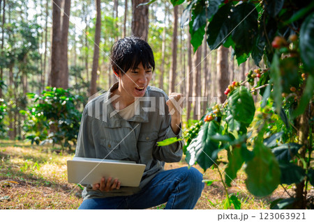 Harvest coffee bean ripe Red berries typing laptop computer check quality control plant coffee tree. Smart farmer using laptop in green coffee farm sustainable quality control agriculture technology Harvest coffee bean ripe Red berries typing laptop computer check quality control plant coffee tree. Smart farmer using laptop in green coffee farm sustainable quality control agriculture technology 123063921