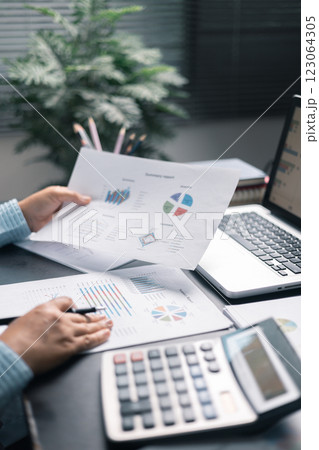 Finance bank tax expense accounting budget money businessman hand use calculator Financial calculate accountant close up calculator with graph chart write office desk Business expense analysis saving 123064305