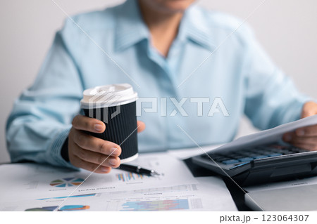 Finance bank tax expense accounting budget money businessman hand use calculator Financial calculate accountant close up calculator with graph chart write office desk Business expense analysis saving 123064307