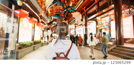 woman traveler visiting in Shanghai, China. Happy Female Tourist sightseeing and shopping in Yuyuan Old Street market at night. landmark and popular for tourism attractions. Travel and Vacation woman traveler visiting in Shanghai, China. Happy Female Tourist sightseeing and shopping in Yuyuan Old Street market at night. landmark and popular for tourism attractions. Travel and Vacation 123065299