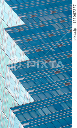 Another modern glass building with a unique stepped design, showcasing contemporary architecture and reflective surfaces. Another modern glass building with a unique stepped design, showcasing contemporary architecture and reflective surfaces. 123067277