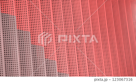 Red Perforation. A vibrant metal facade with rhythmic perforations and layered depth, playing with light and shadow. 123067316