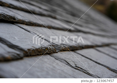 Slate roof tiles create a textured surface that enhances the architectural beauty of buildings 123067457