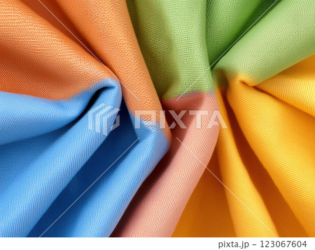 Vibrant fabric in orange, blue, green, and yellow hues, showcasing texture and color blending beautifully 123067604
