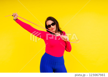 Full length photo of a young smiling fat overweight woman wearing sportswear Full length photo of a young smiling fat overweight woman wearing sportswear 123067981